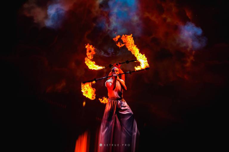 Performer amid fiery stage lights in OPERAP:ŚLEPCY