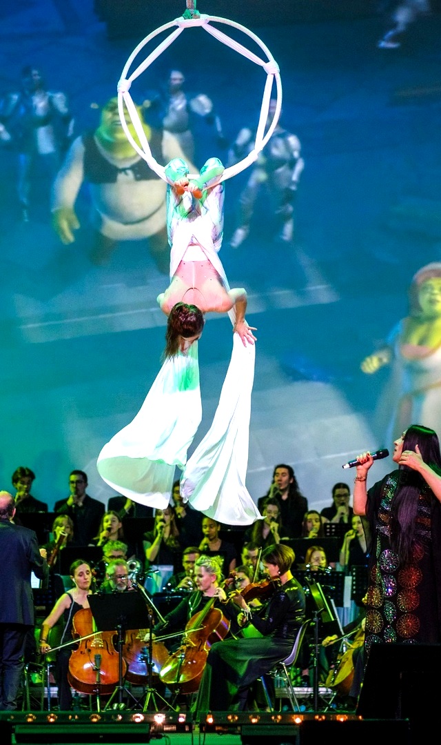 Aerialist in a hoop above the Hollywood in Dance orchestra